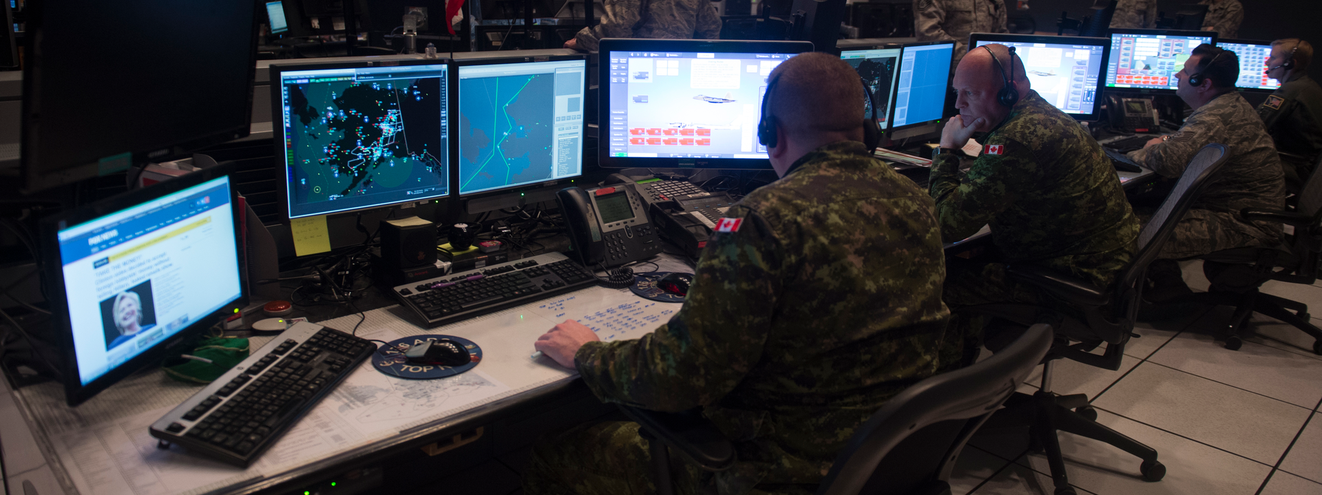Canadian soldiers sitting at computers in ops room