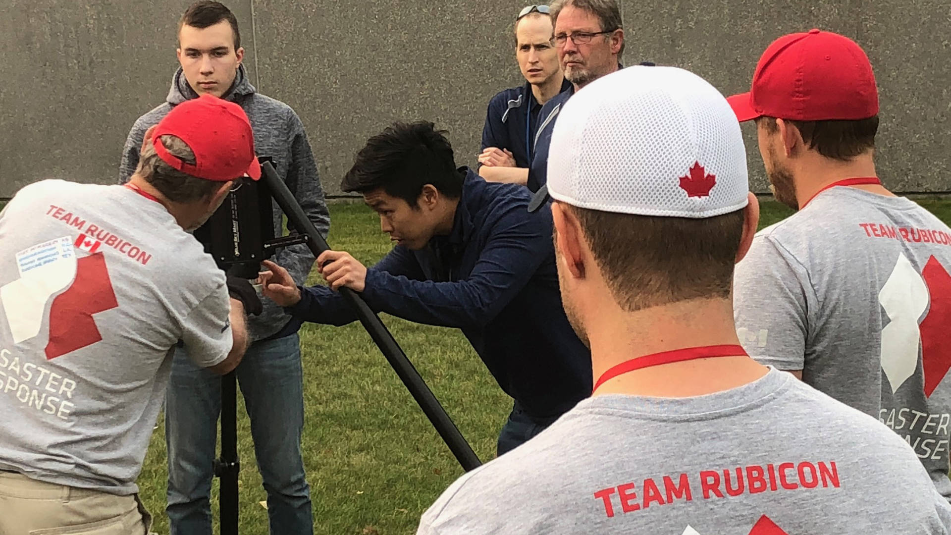 Engineering specialists from GDMS-C demonstrate EmergencySHIELD communications equipment to volunteers from Team Rubicon Canada. 