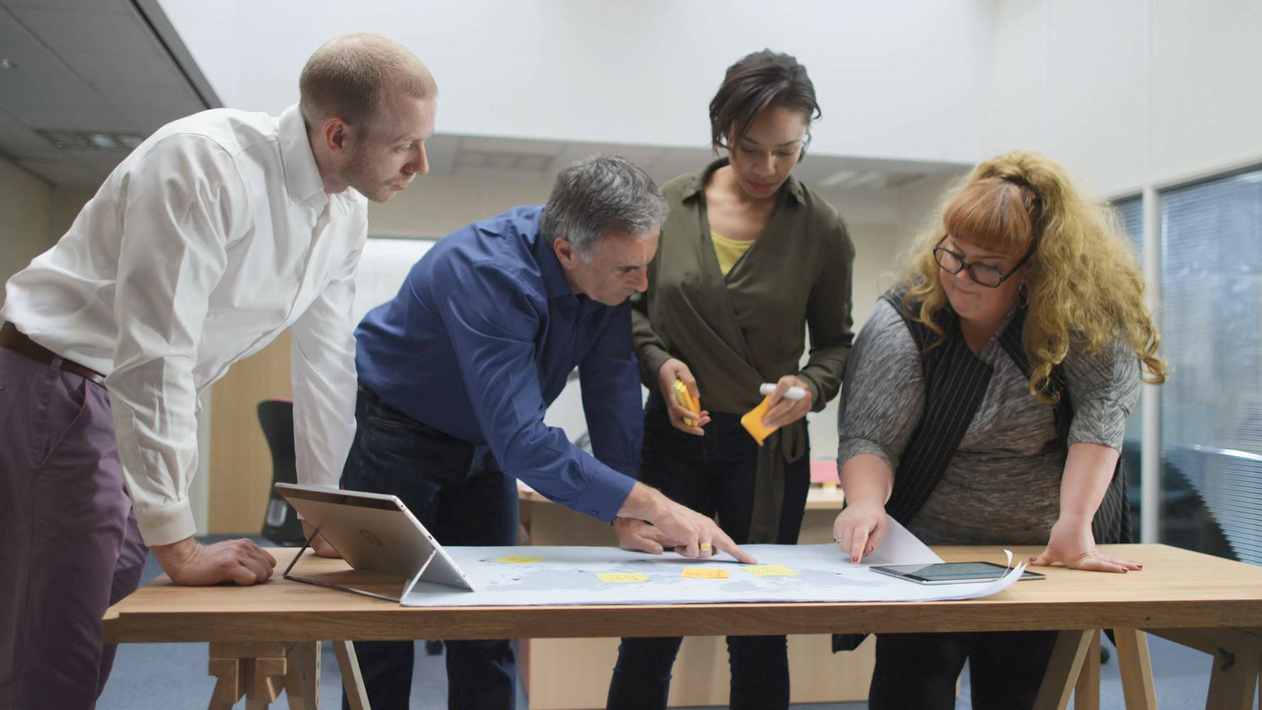 Group of employees looking at a map.