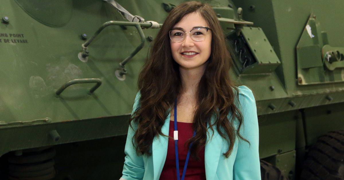 Photo of colleague smiling in front of LAV.