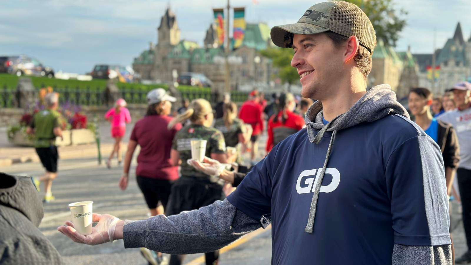 Colleague handing out water at GD water station.