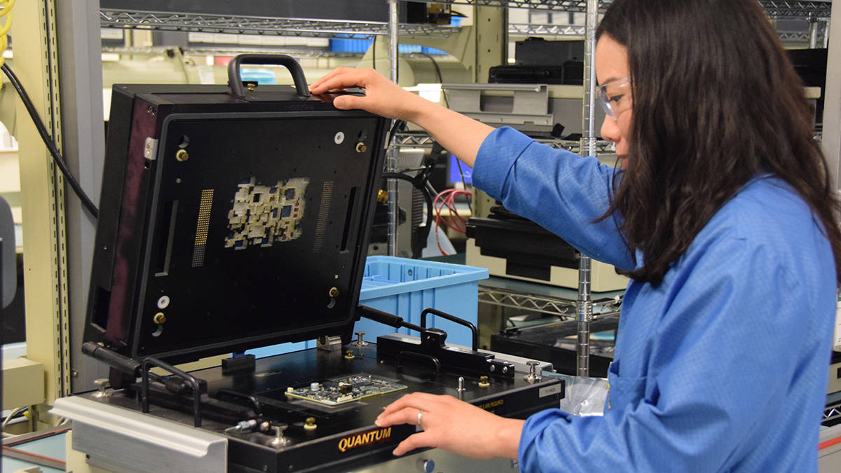 Woman repairing circuit card