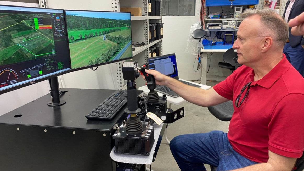 Man controlling unmanned aerial vehicle at console