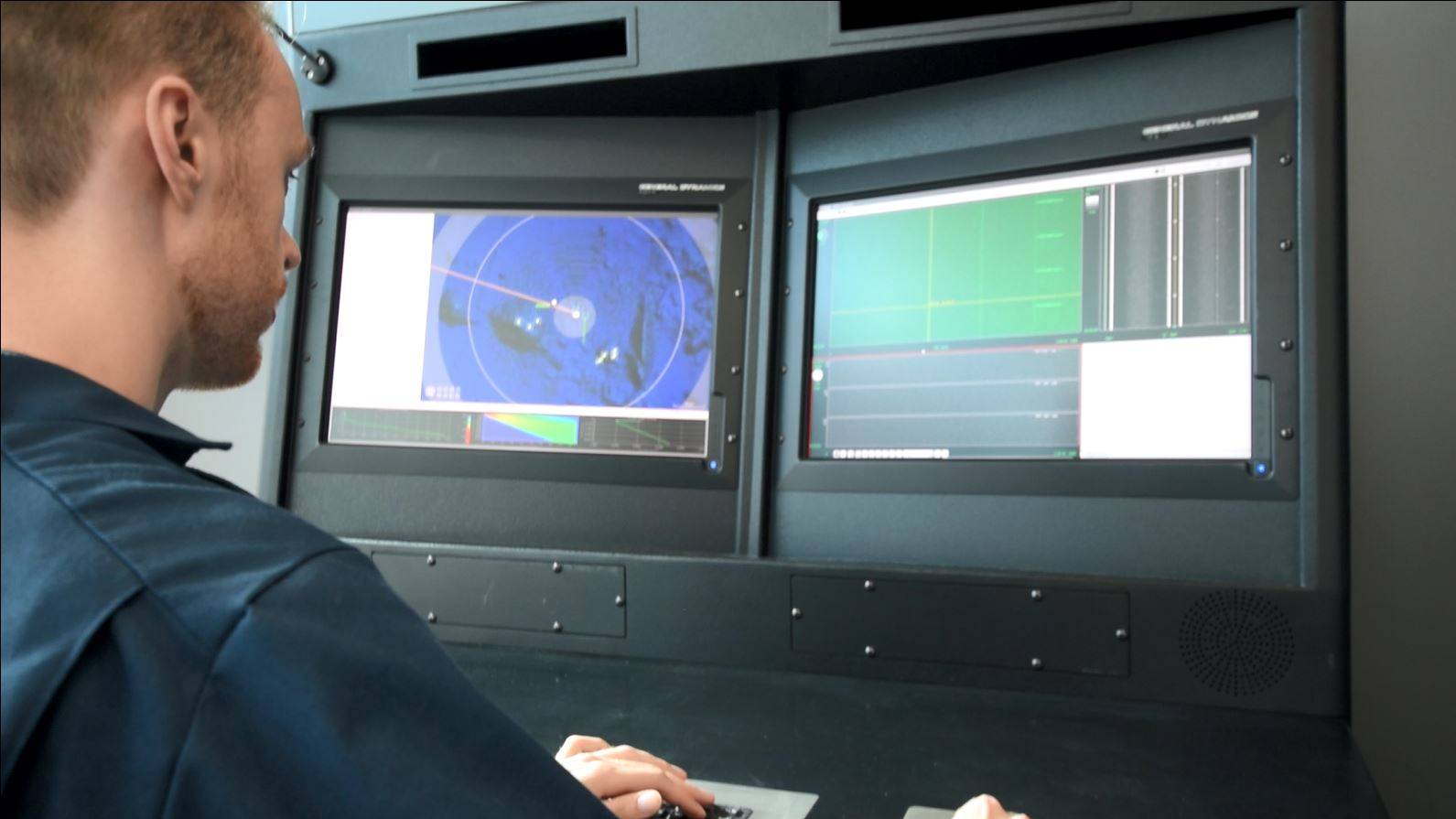 man sitting in front of two monitors