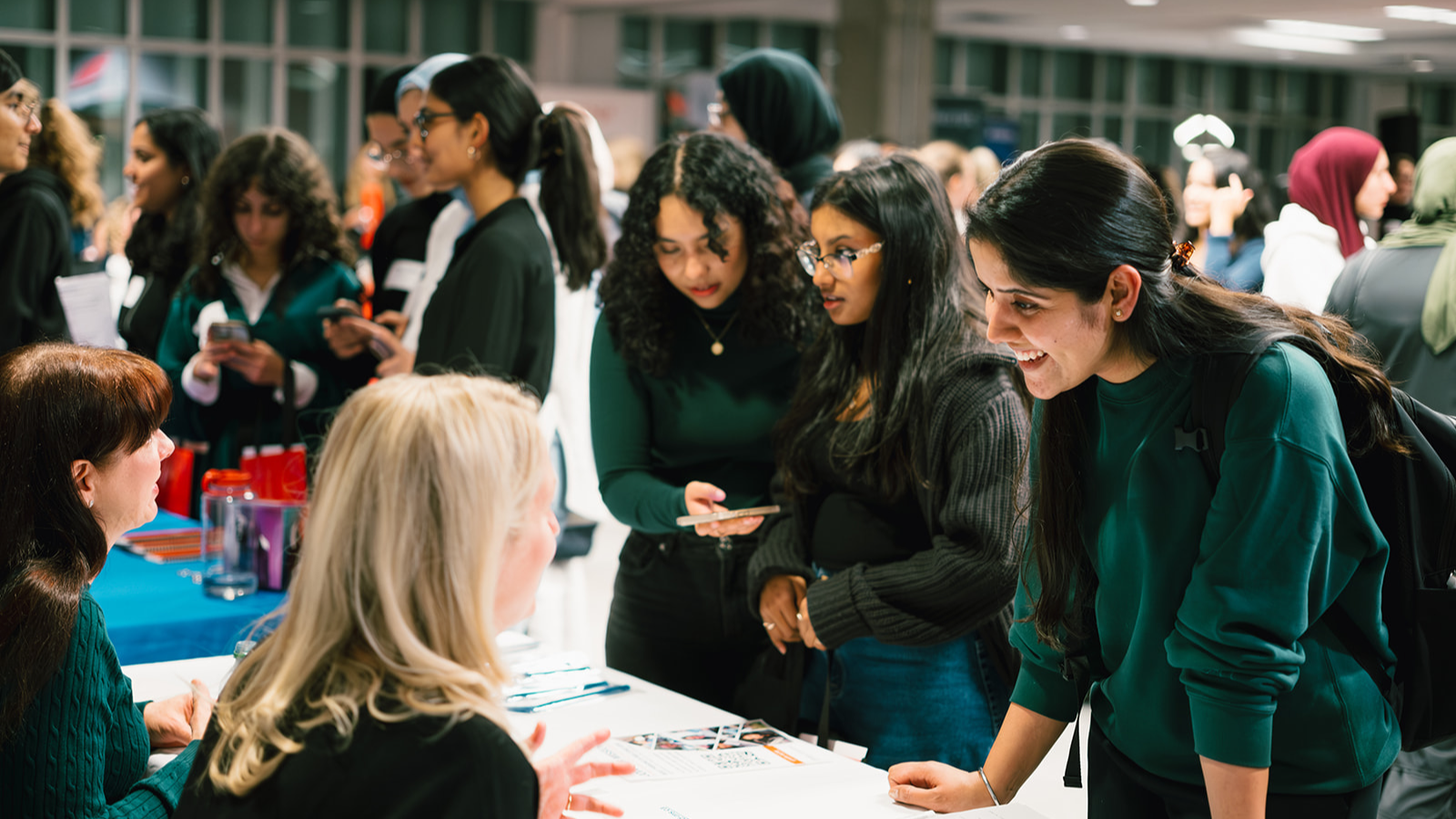 Recruiters chatting with students at Carleton career fair.