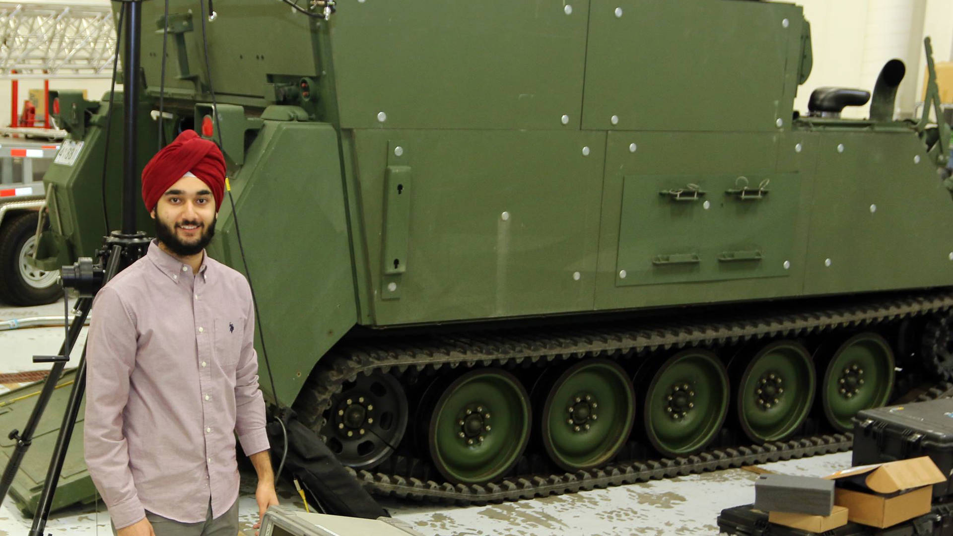 Man Standing in Front of Army Tank