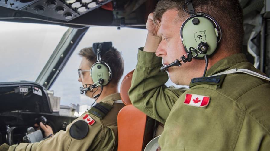 Two air force operators sitting in cockpit