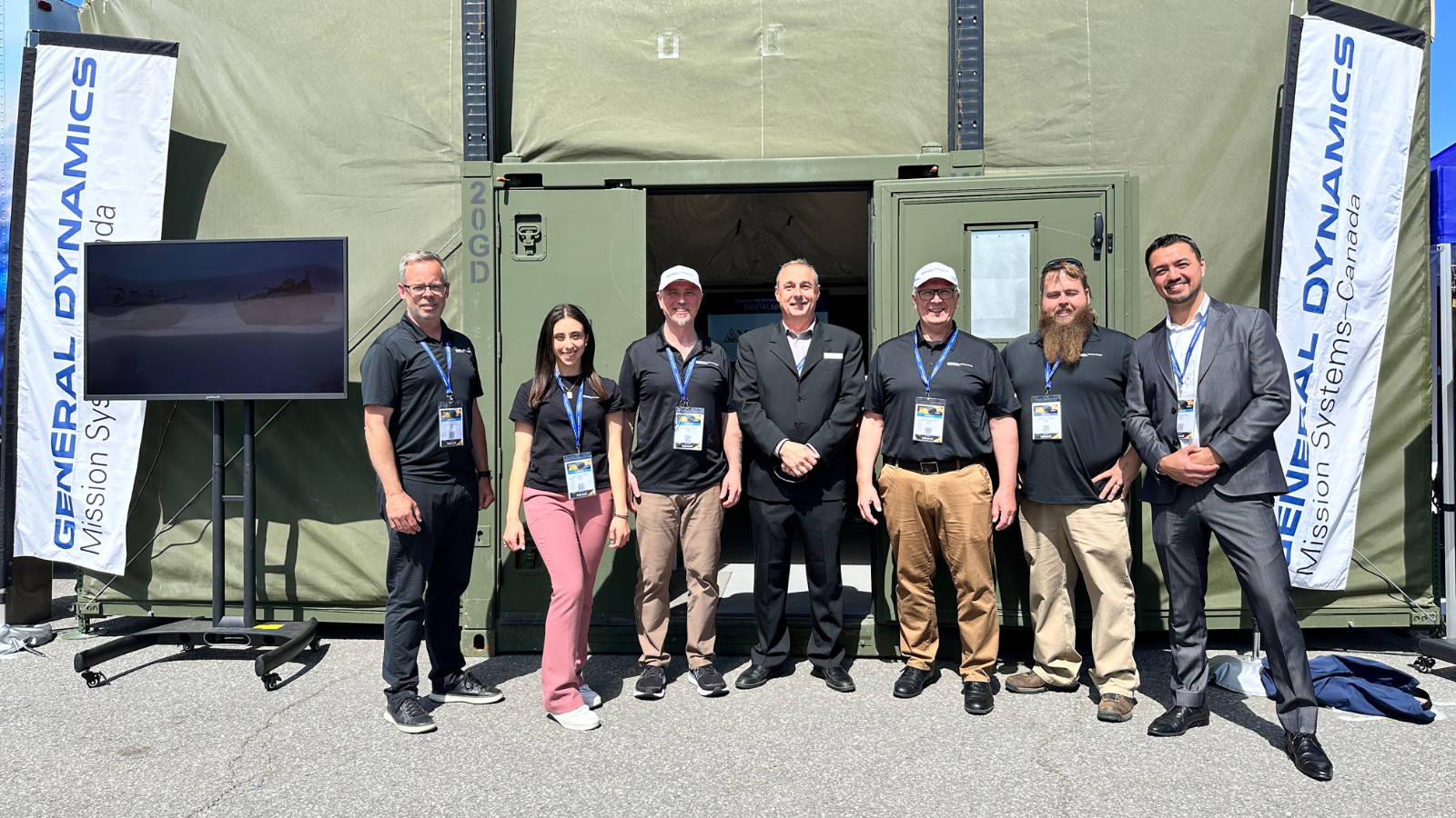 Colleagues in front of tent at CANSEC.