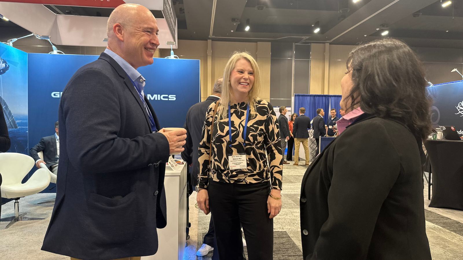 Colleagues chatting with customer at DEFSEC in Halifax